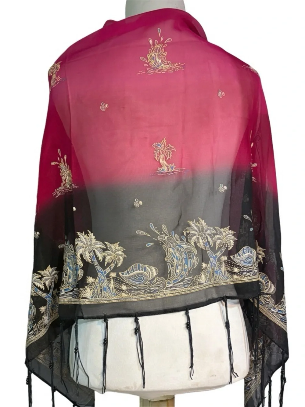 magenta and black scarf features palm tree motifs and black tassels along the ed
